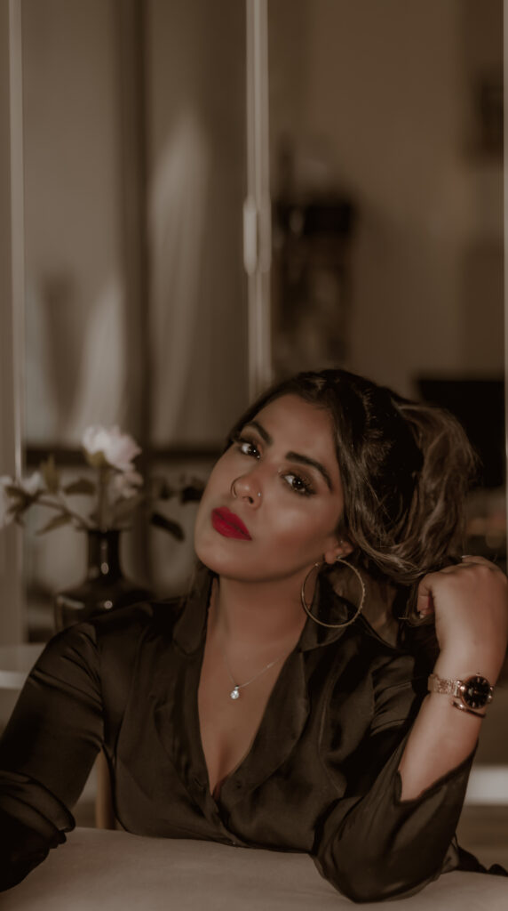 Marzia Dossal in black outfit and red lipstick