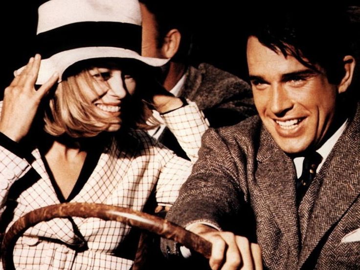 Bonnie and Clyde in a car, holding a wheel.