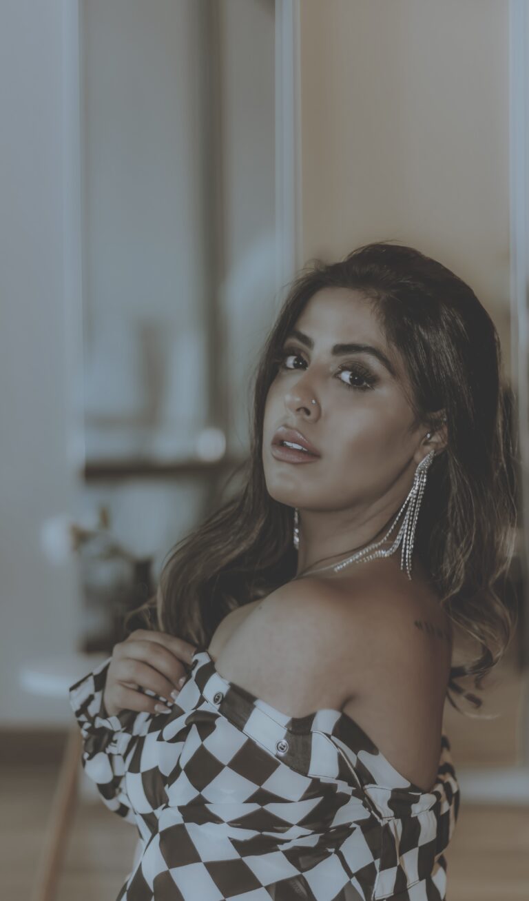 Marzia Dossal in a checkered shirt, looking confidently into the camera