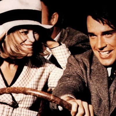 Bonnie and Clyde Bonnie and Clyde in a car, holding a wheel.
